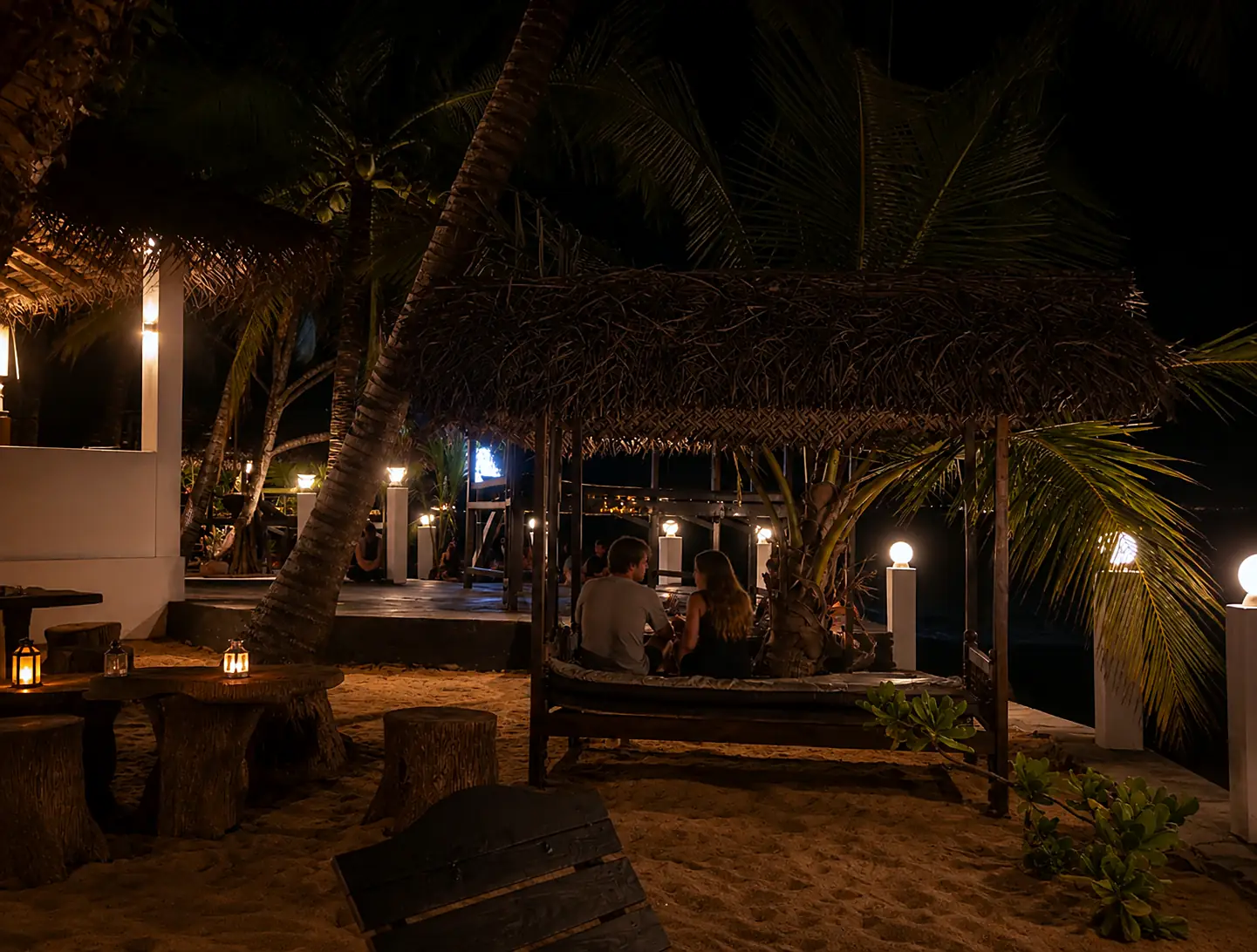 Thatched cabana lit by lamps in the evening near CanRoyal Resort, Tangalle