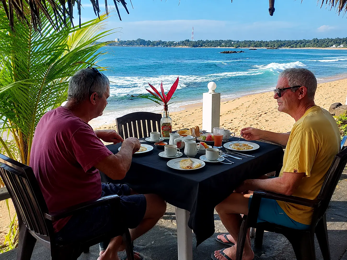 Guests having breakfast at a table overlooking the sea near CanRoyal Resort, Tangalle
